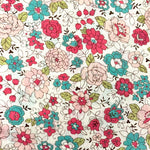 White cotton lawn fabric with pink, teal, and blush floral print pattern