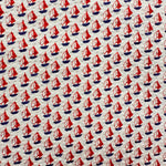 White seersucker fabric with red sailboat print and navy blue hulls pattern