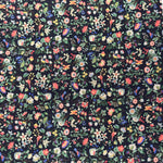 Navy blue corduroy fabric with dense multicolor floral and paisley print pattern