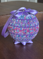 Purple smocked ornament ball with floral fabric, zigzag embroidery, satin bow and ribbon hanger