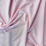 Soft pink velveteen fabric with smooth texture and gentle draping folds