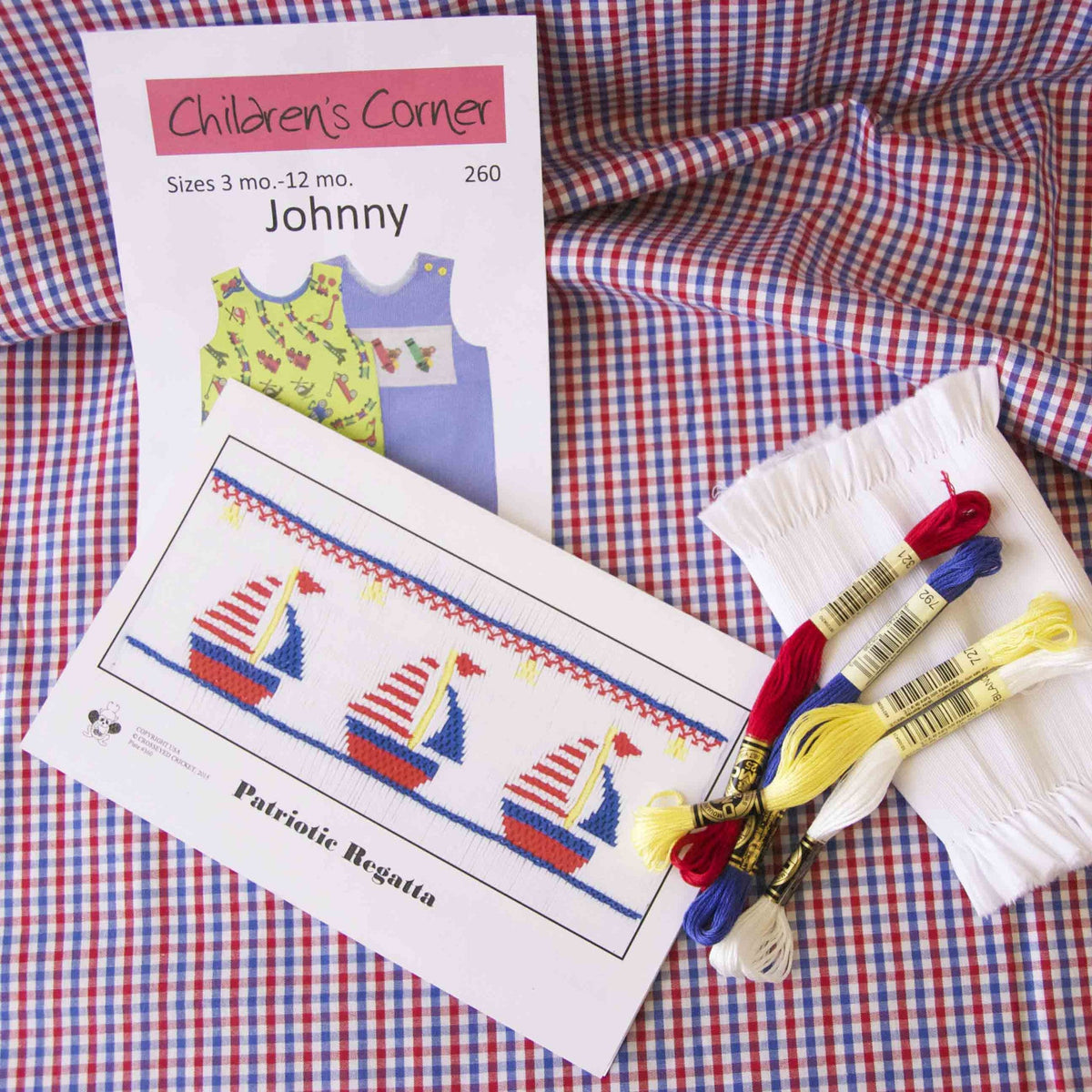 Red and blue gingham check fabric with smocking pattern kit and embroidery floss