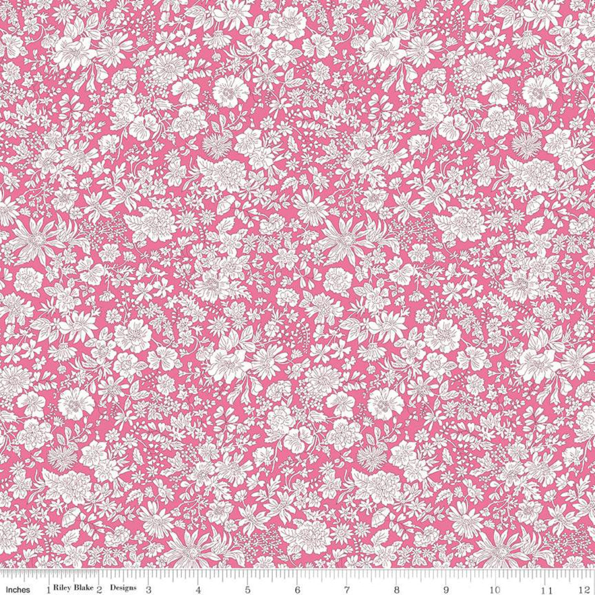 Bright pink quilting fabric with dense white floral print by Riley Blake Designs