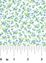 White cotton fabric with small scattered blue flowers and green leaves floral print