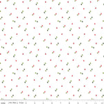 White quilting fabric with scattered small red and green Christmas trees pattern