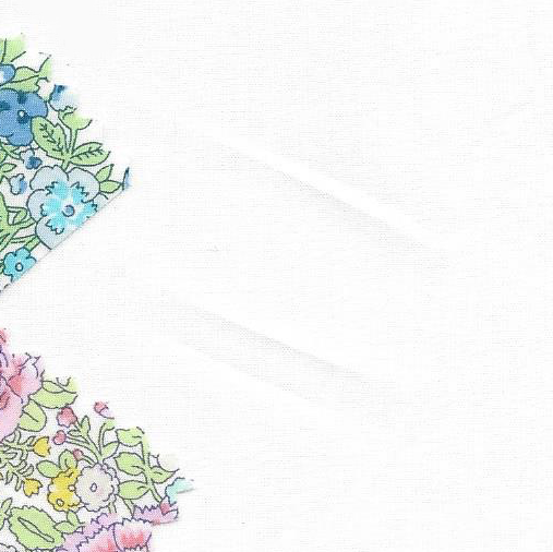 White Liberty Tana Lawn fabric with two floral print fabric swatches in corners