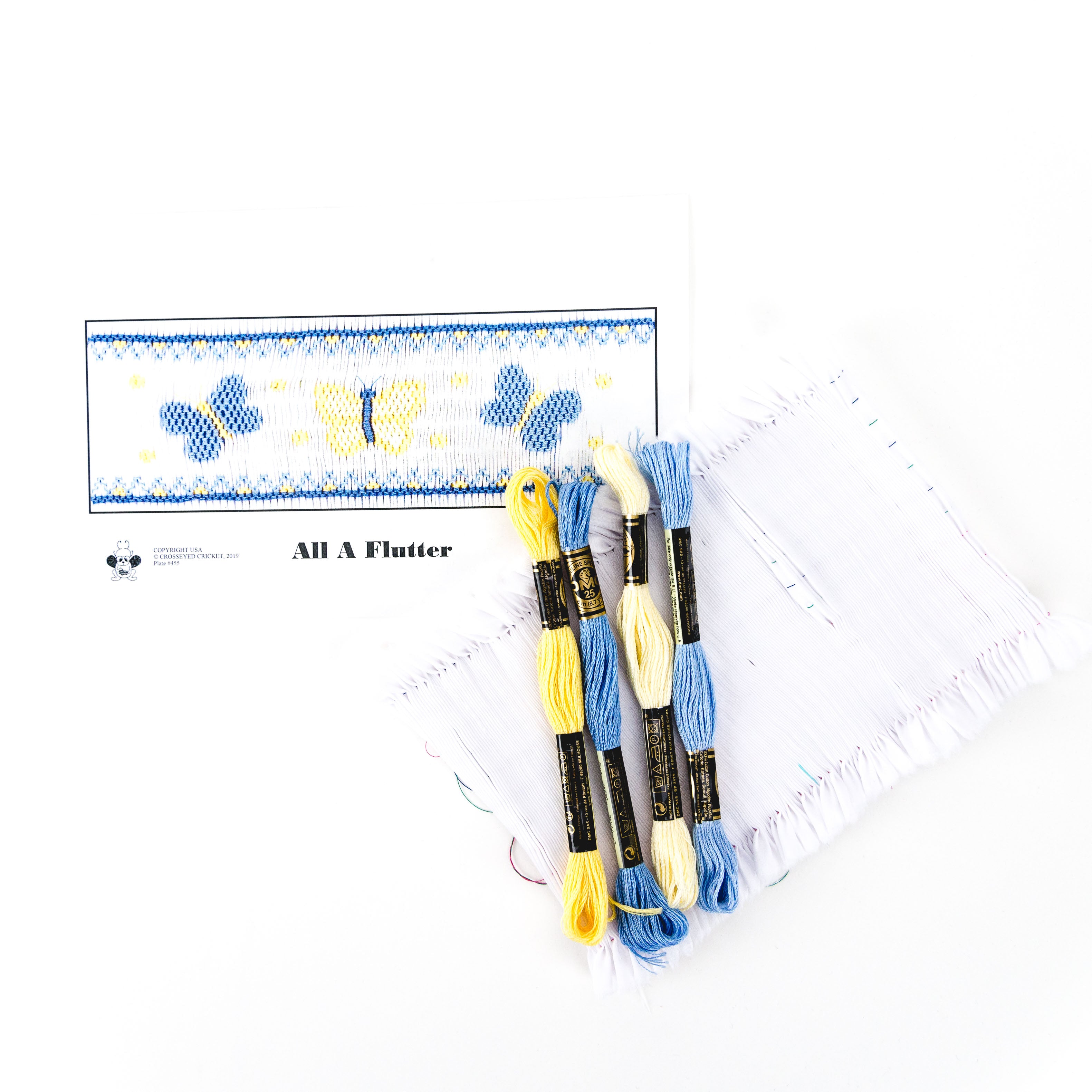All A Flutter smocking kit with blue and yellow floss skeins and pre-pleated white fabric