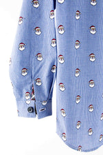 Blue micro check fabric with repeating Santa Claus face pattern, shown as a dress shirt