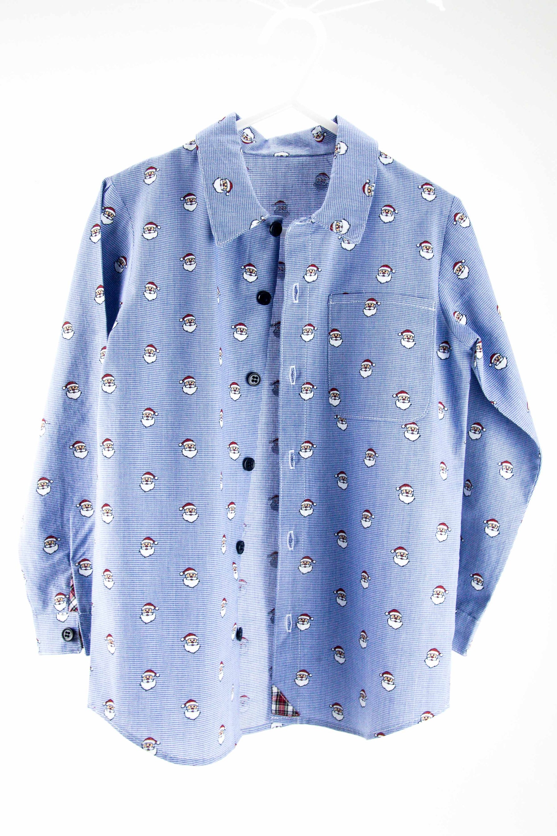 Blue micro check fabric shirt with repeating Santa Claus face pattern and dark buttons